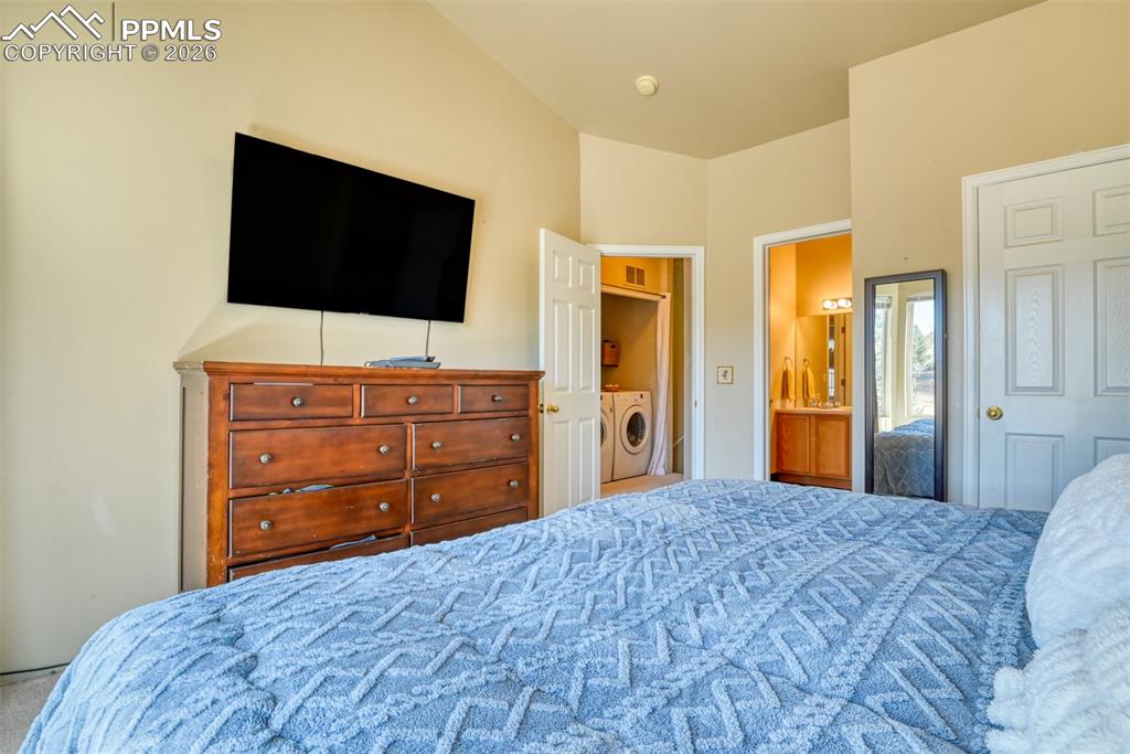 Image 26 of 35: Bedroom featuring washer / clothes dryer and ensuite bath