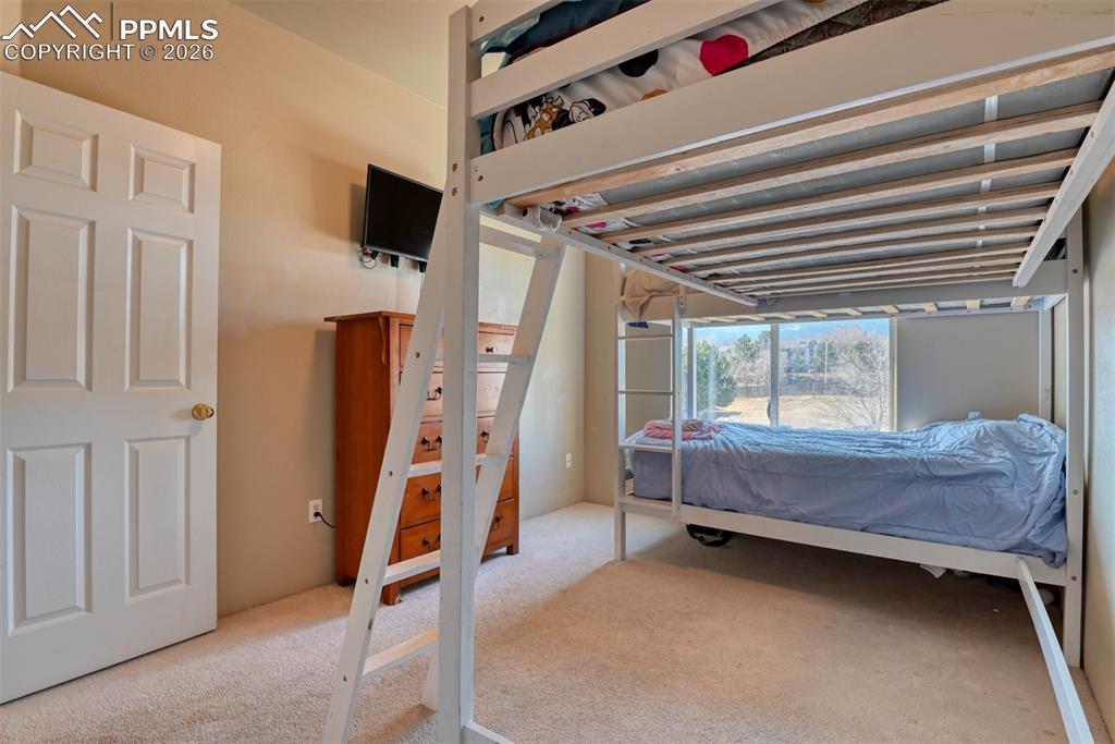 Image 30 of 35: Bedroom with light carpet