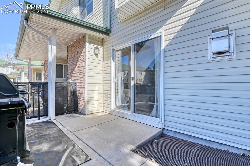 Image 35 of 35: View of patio featuring area for grilling