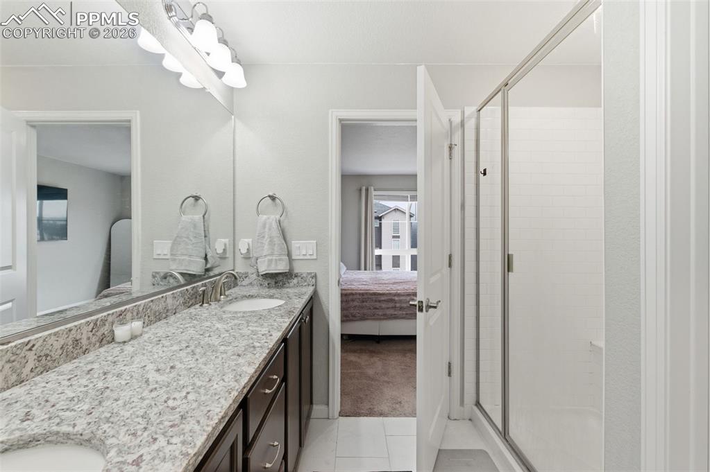 Image 19 of 38: Granite counters & shower is to the right