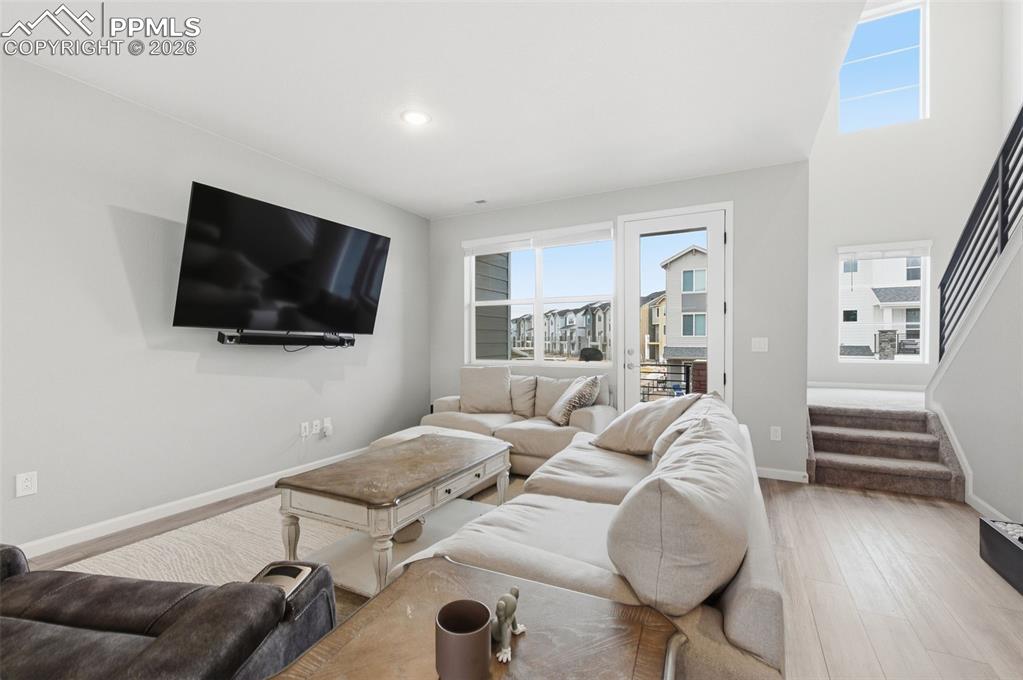 Image 3 of 38: At opposite end of living room is a door to access private balcony