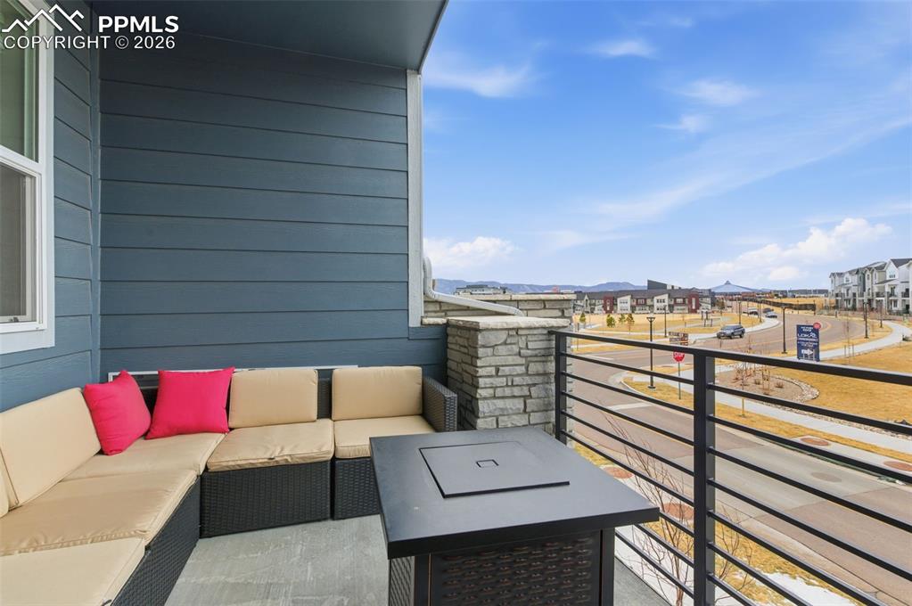 Image 5 of 38: Private balcony with attractive rod iron railing and view of park