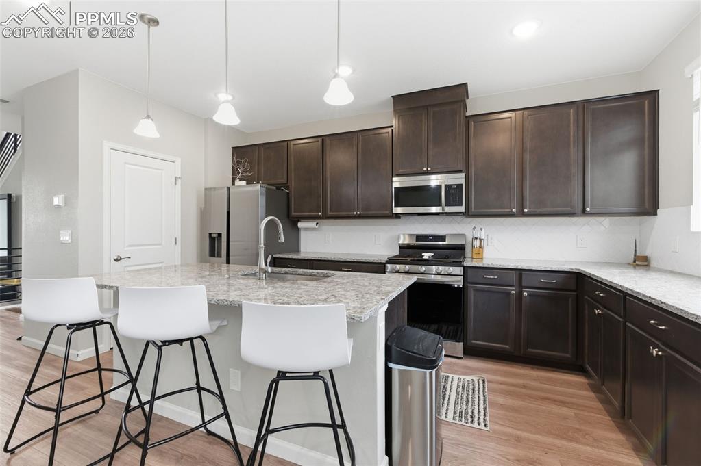 Image 8 of 38: Pendant lights over spacious center island