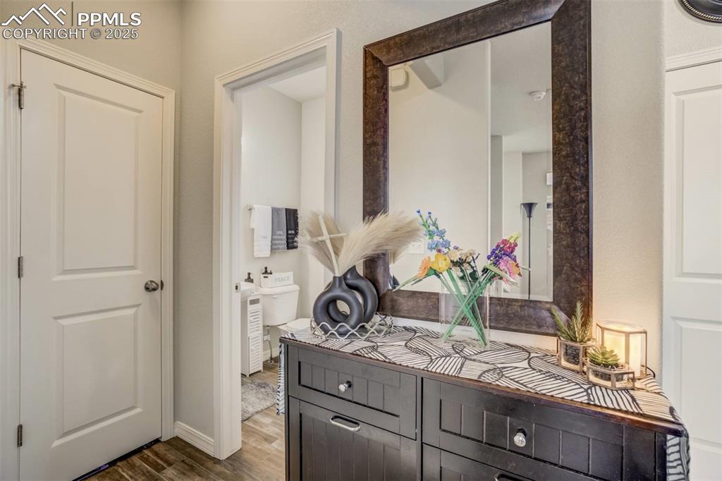 Image 10 of 27: Corridor with wood finished floors and baseboards