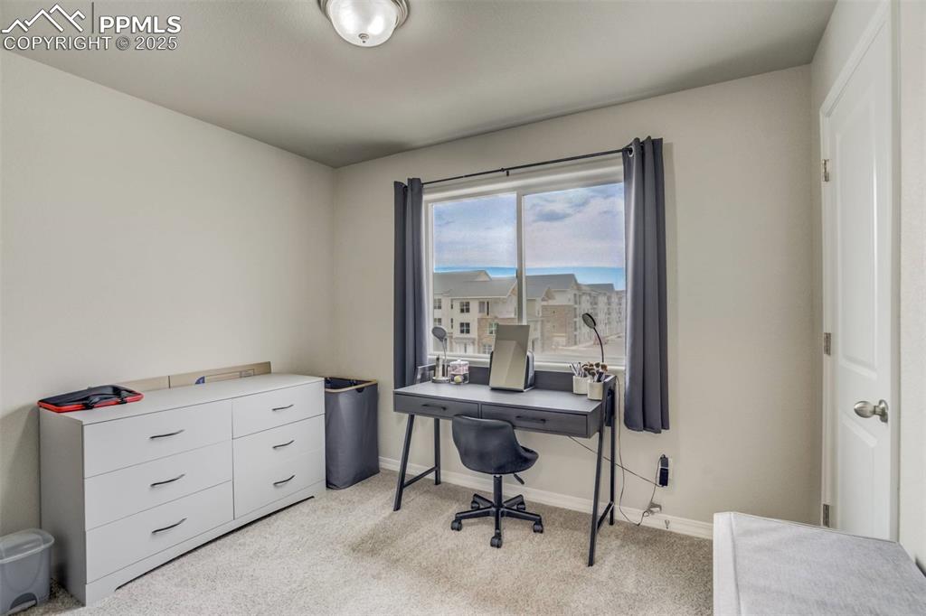 Image 19 of 27: Office space with light colored carpet and baseboards