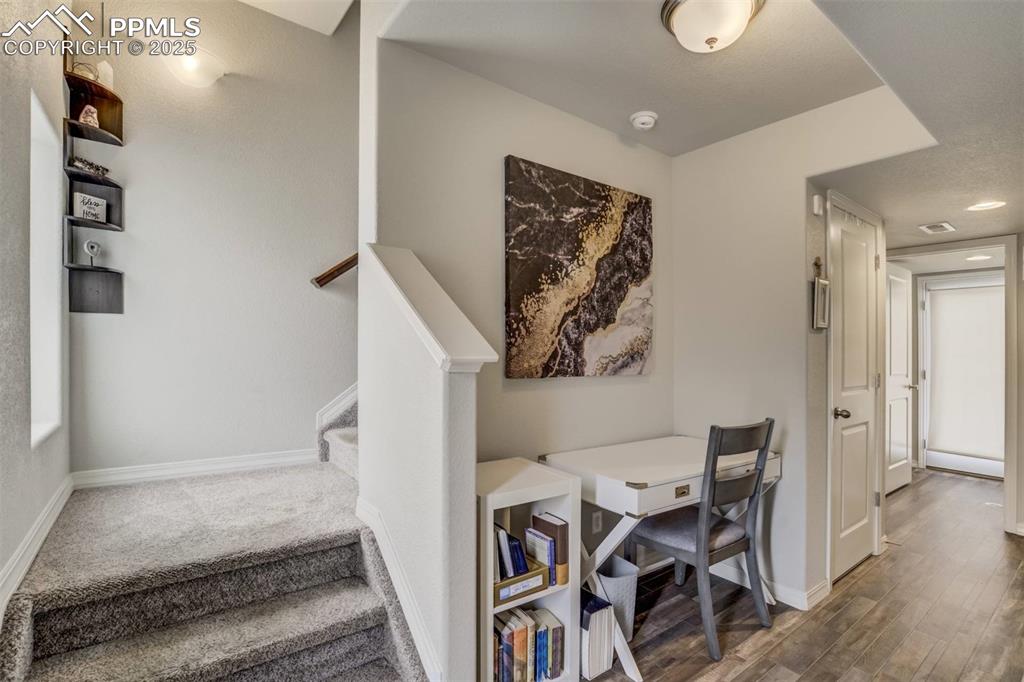 Image 4 of 27: Stairs featuring baseboards and wood finished floors