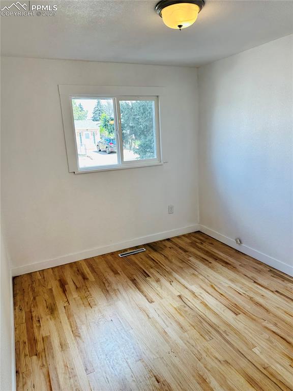 Image 5 of 9: Unfurnished room with wood finished floors