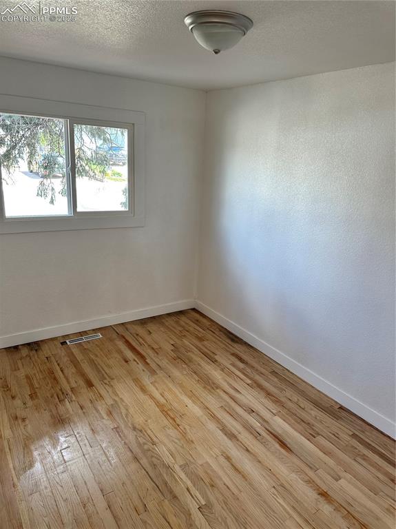 Image 6 of 9: Unfurnished room featuring light wood-type flooring and baseboards