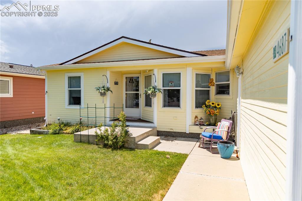 Caption: Entrance to property with a yard