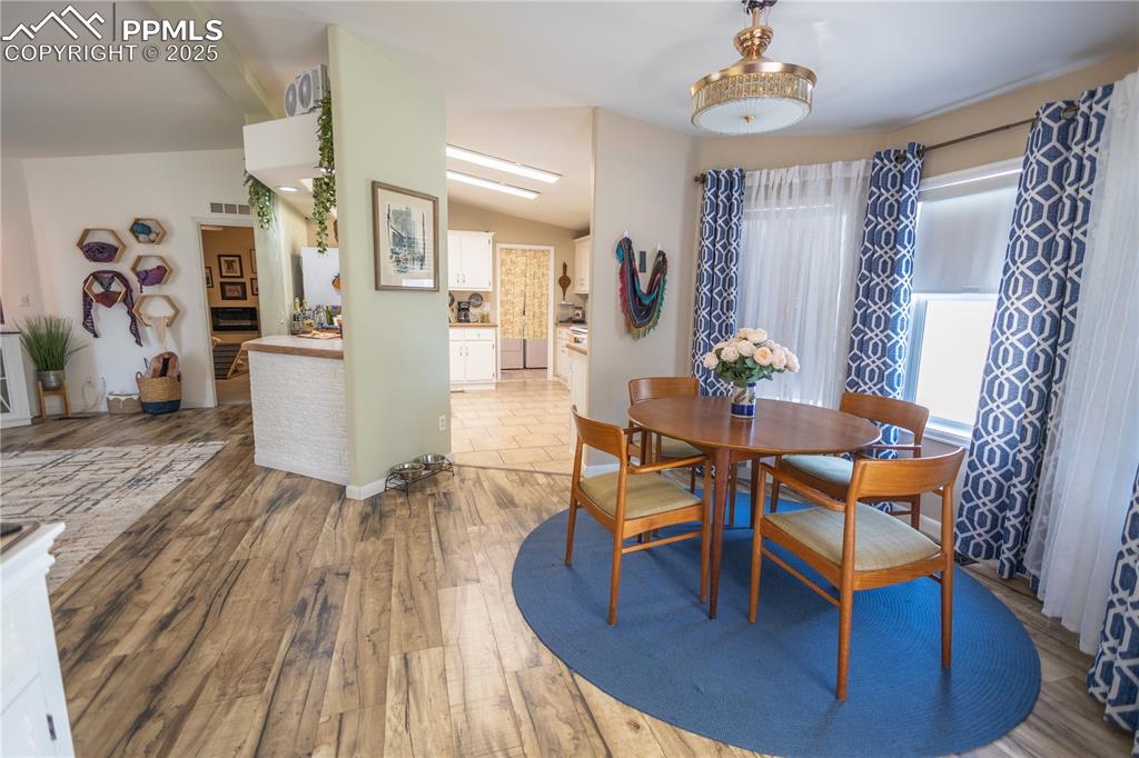 Image 10 of 19: Dining area featuring lofted ceiling and light wood-style flooring