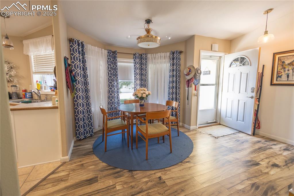 Image 11 of 19: Dining area with wood finished floors