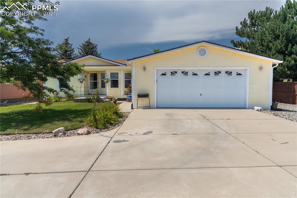 Image 2 of 19: Single story home with driveway and a front lawn