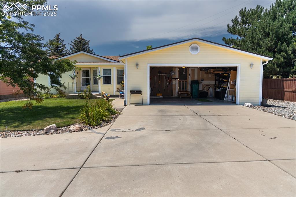 Image 3 of 19: View of front of house featuring an attached garage and driveway