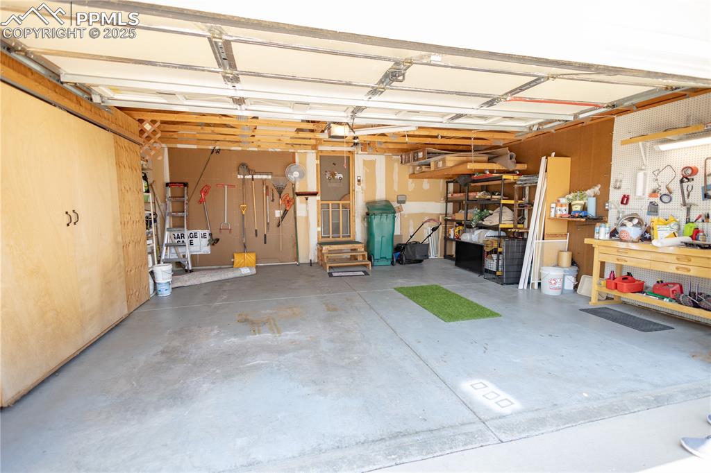 Image 4 of 19: Garage featuring a workshop area