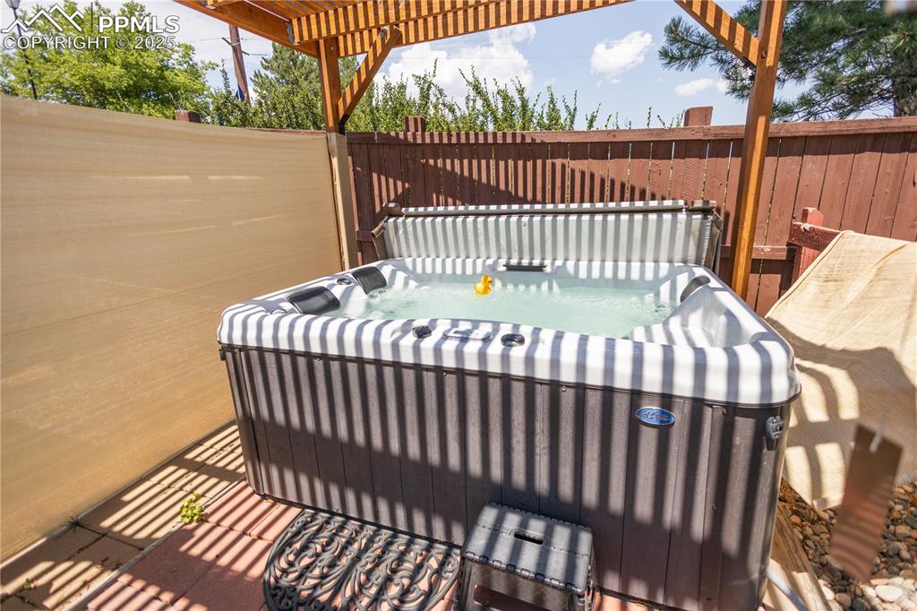 Image 5 of 19: View of patio featuring a hot tub