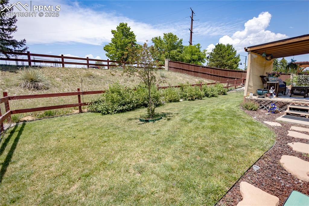 Image 8 of 19: Fenced backyard with a deck