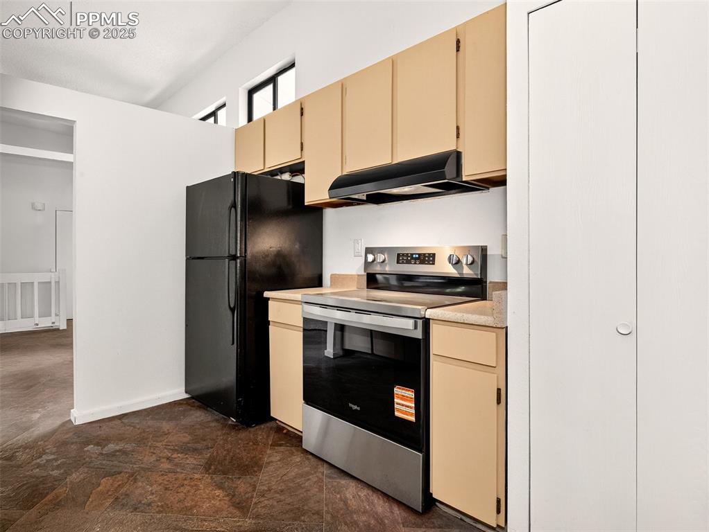 Image 10 of 44: Stainless steel sink, dishwasher, and electric glass-top range