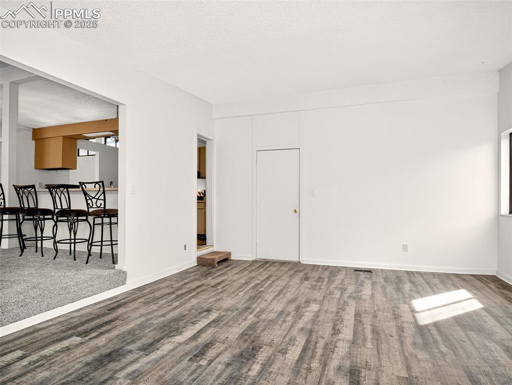 Image 11 of 44: Family room with luxury vinyl flooring and access to the 2 car garage