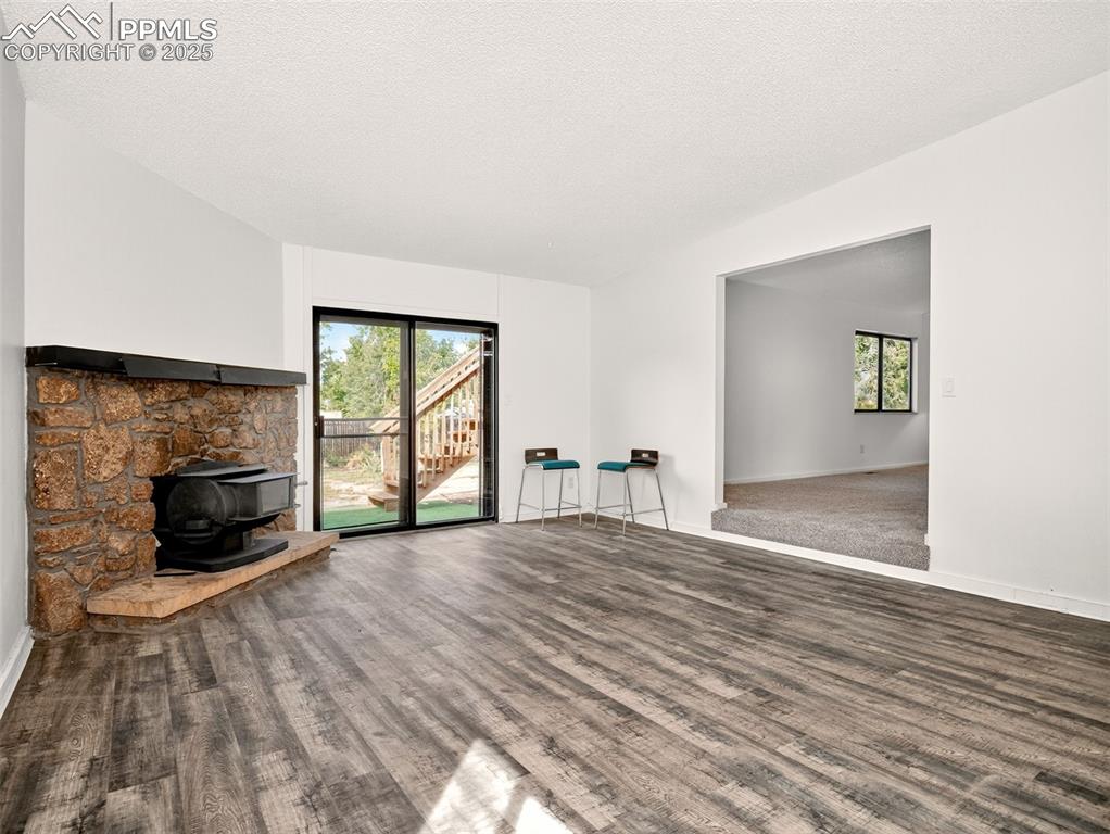 Image 12 of 44: Past the large breakfast bar is the family room and access to the backyard.