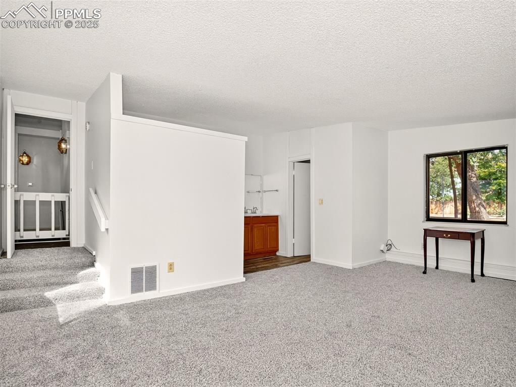 Image 15 of 44: Master bedroom with vaulted ceilings and adjoining bathroom.