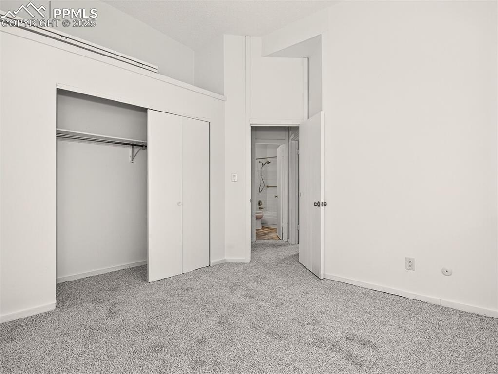 Image 24 of 44: Third main level bedroom with high ceilings and storage space.