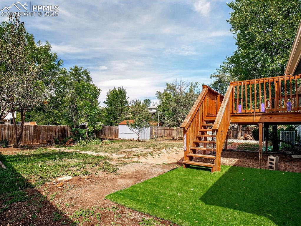 Image 38 of 44: Walk out from the family room to a large yard and elevated wood deck