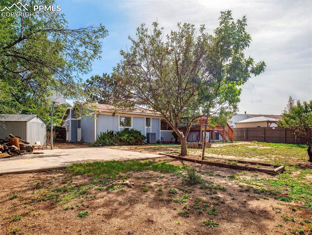 Image 41 of 44: Large patio space in the backyard with included basketball hoop
