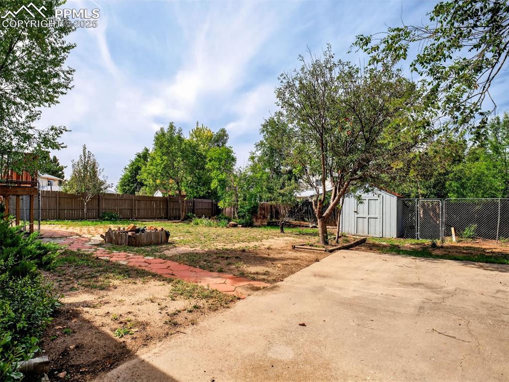 Image 42 of 44: Fully fenced and includes a storage shed and covered coop