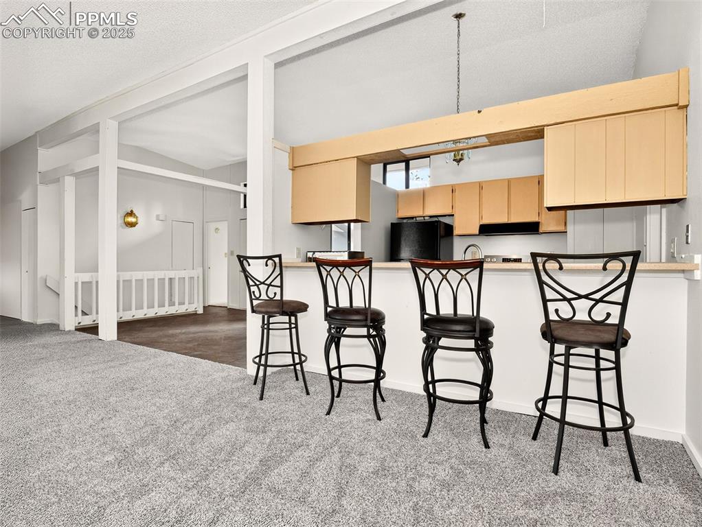 Image 8 of 44: Living space with vaulted ceilings.