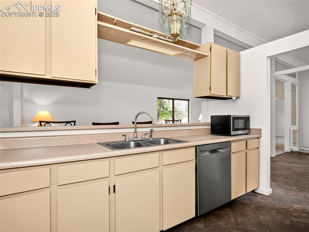 Image 9 of 44: Just off the dining space and living room is the kitchen with a breakfast b