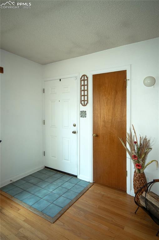 Image 5 of 30: Front Entry with a tile floor