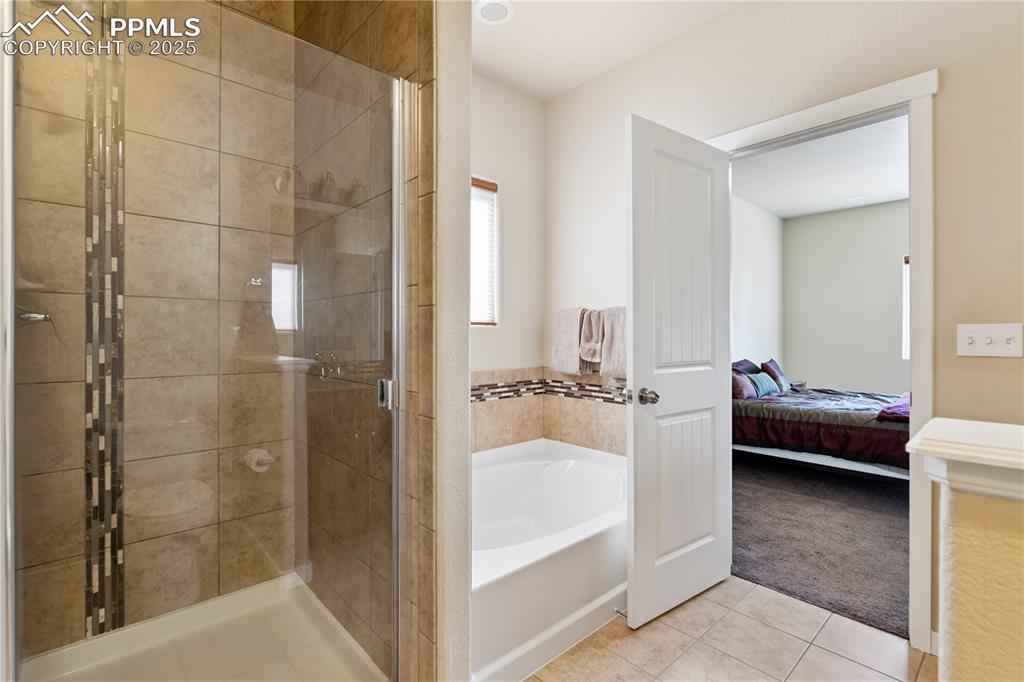 Image 14 of 28: The en-suite has great finishes with ceramic tile inlays and craftsman styl