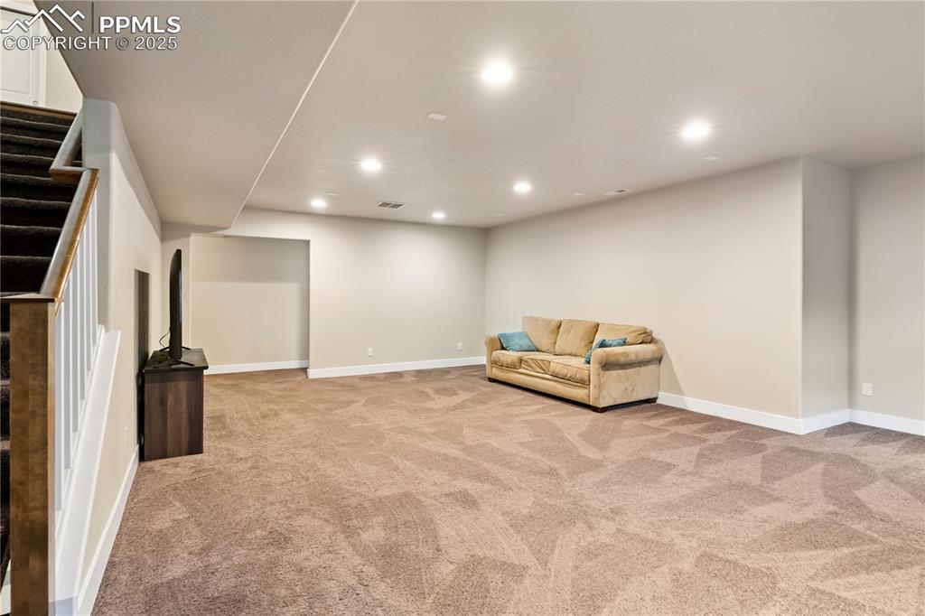 Image 17 of 28: The family room in the basement is so large you could fit both a living roo