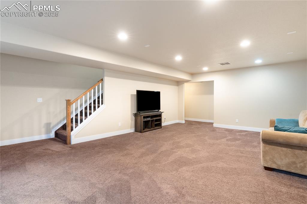 Image 18 of 28: The family room is ready for your theater setup with a surround sound prewi
