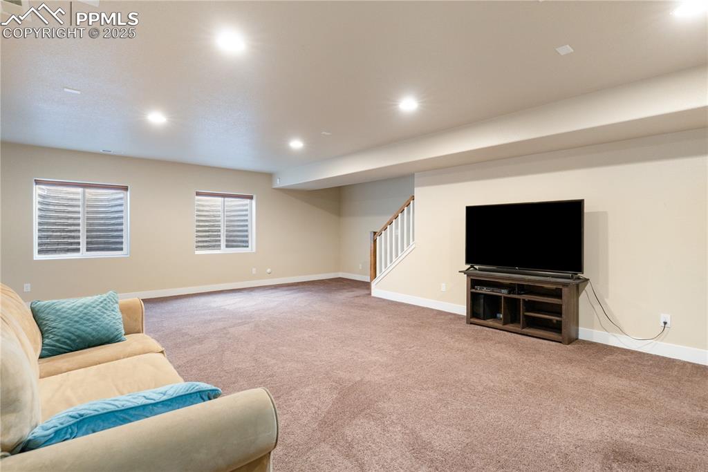 Image 19 of 28: The huge basement family room is well-lit with recessed lighting and ready 