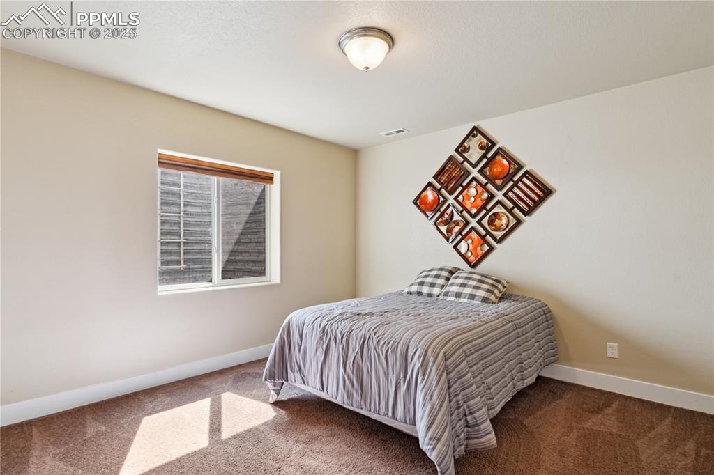 Image 20 of 28: Bedroom #3 of 4 is in the basement and is big enough for anyone who might w