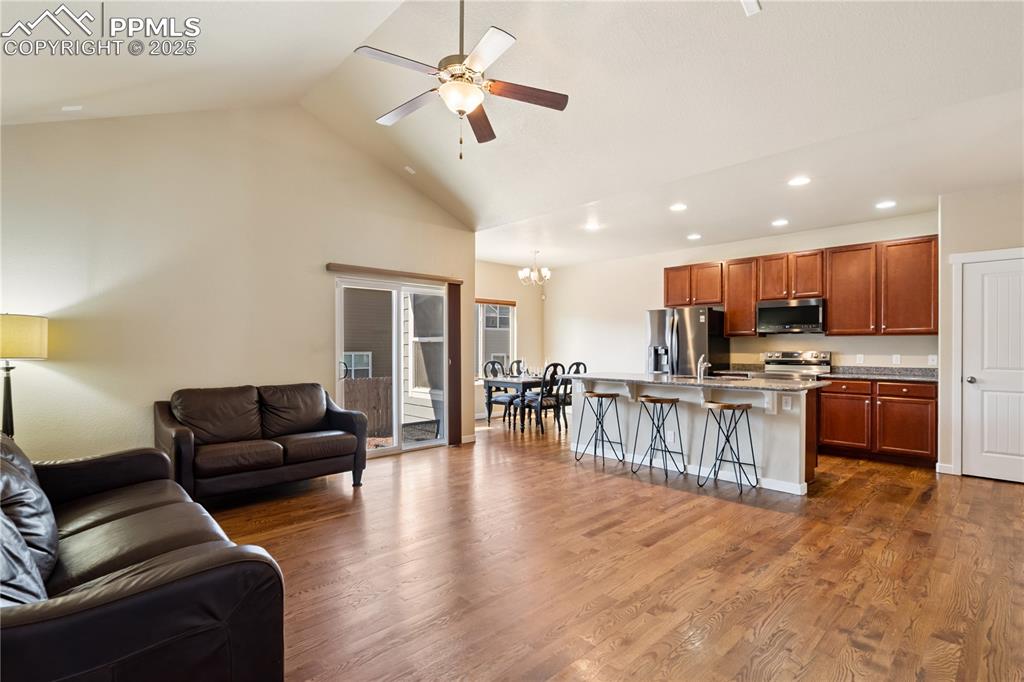 Image 4 of 28: The great room with vaulted ceilings, warm natural tones on solid-oak floor
