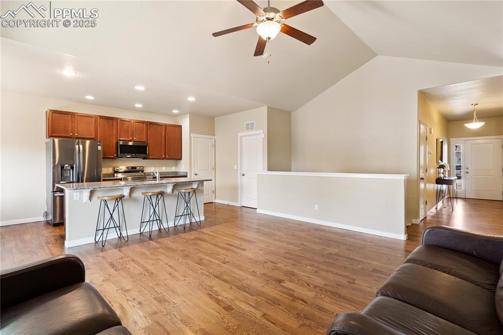 Image 6 of 28: Very generously sized great room with an adjacent breakfast bar and kitchen