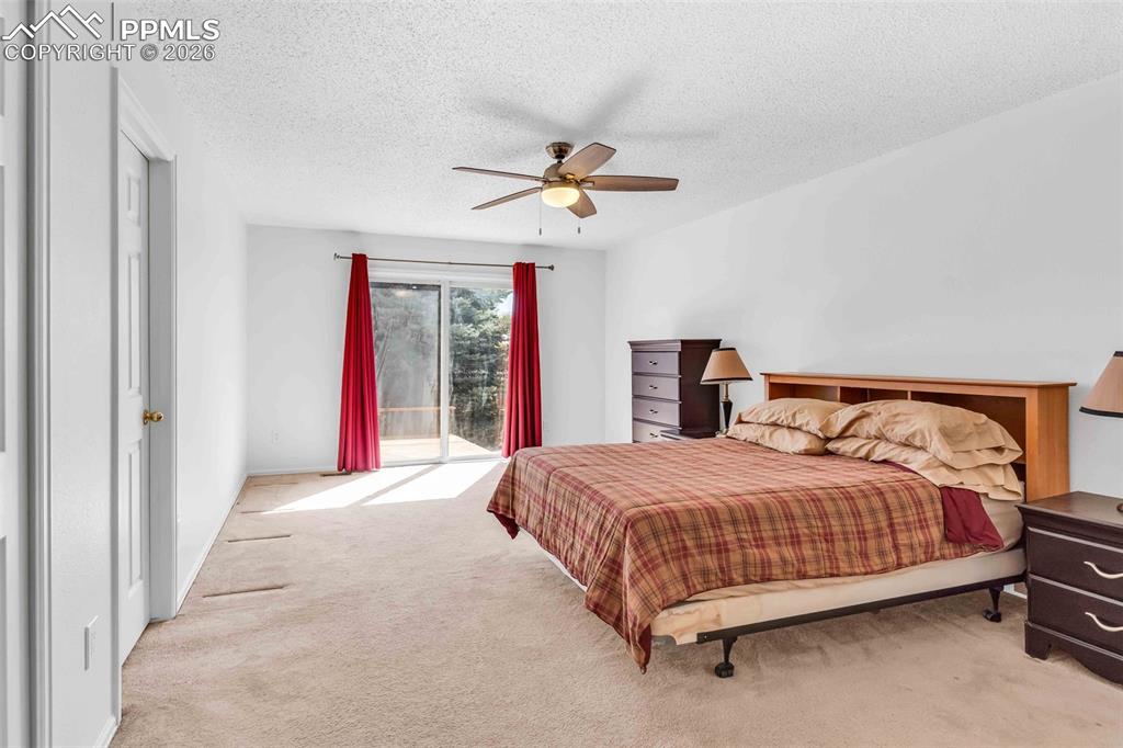 Image 13 of 27: Second angle of master bedroom showing en-suite bathroom entrance, and priv