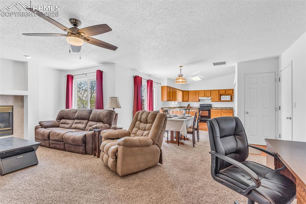 Image 2 of 27: Open-concept living, dining, and kitchen layout with great natural light an