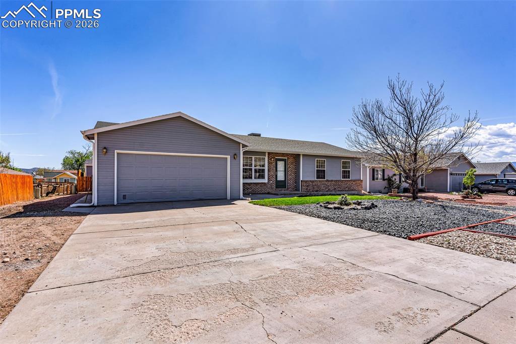 Image 25 of 27: Spacious concrete driveway with additional side-yard access, providing ampl