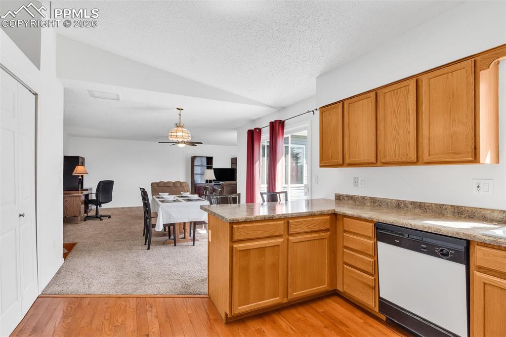 Image 8 of 27: Leading into the spacious dining area featuring a vaulted ceiling, and slid
