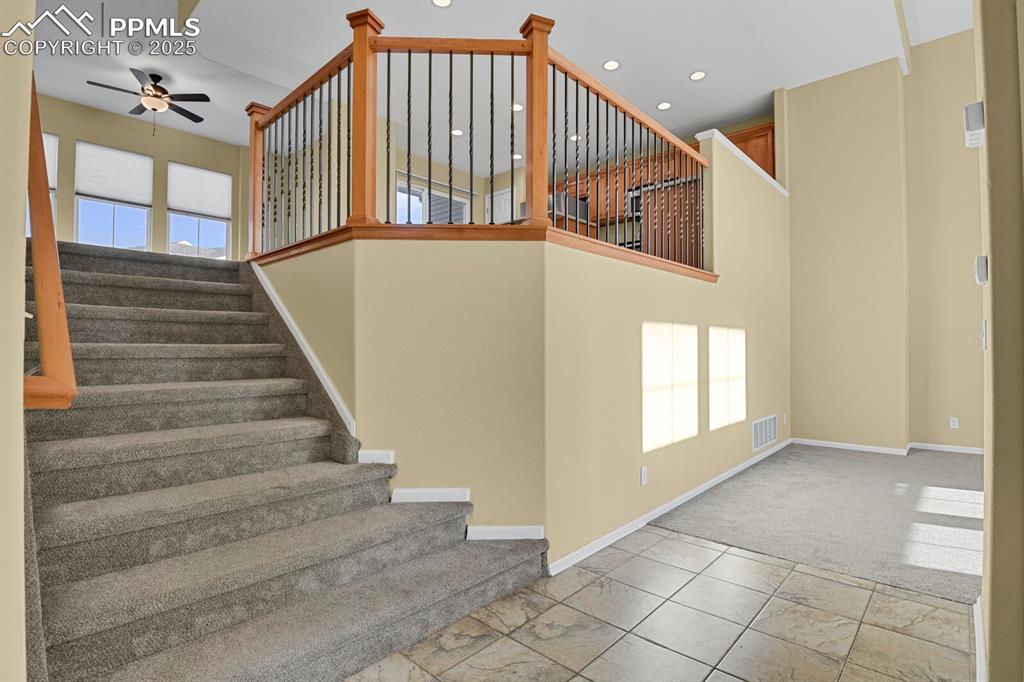 Image 13 of 45: Staircase with carpet flooring, recessed lighting, and ceiling fan