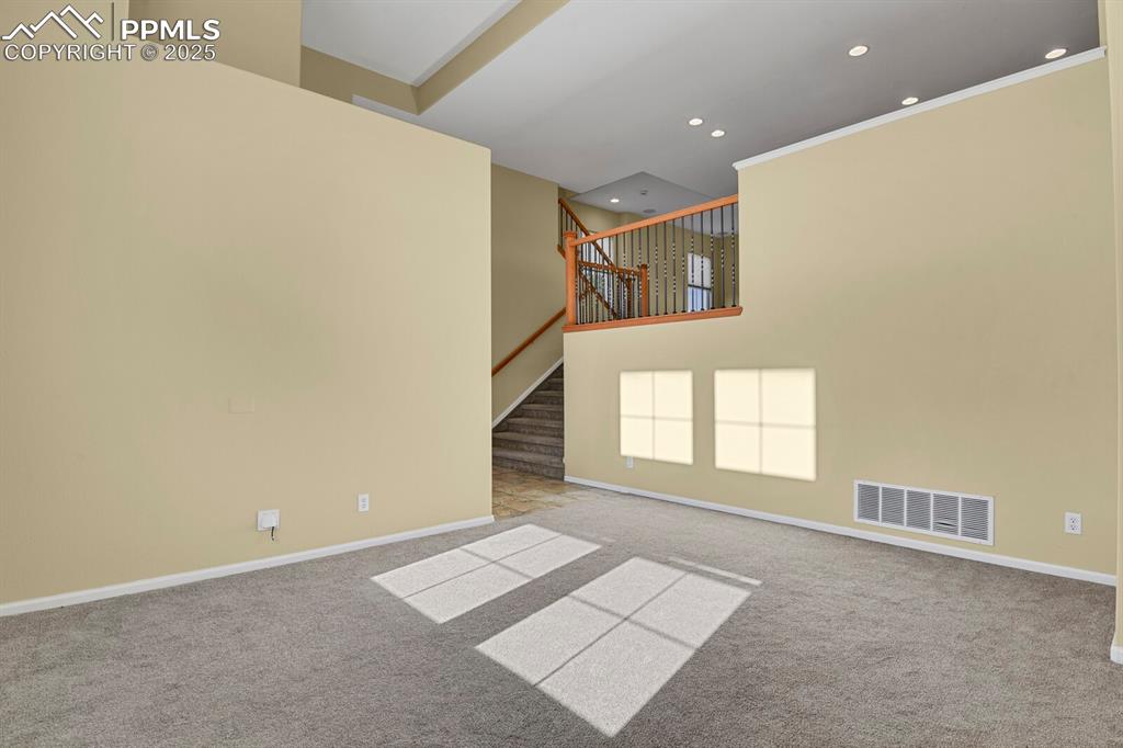 Image 15 of 45: Spare room featuring carpet flooring, recessed lighting, and stairs