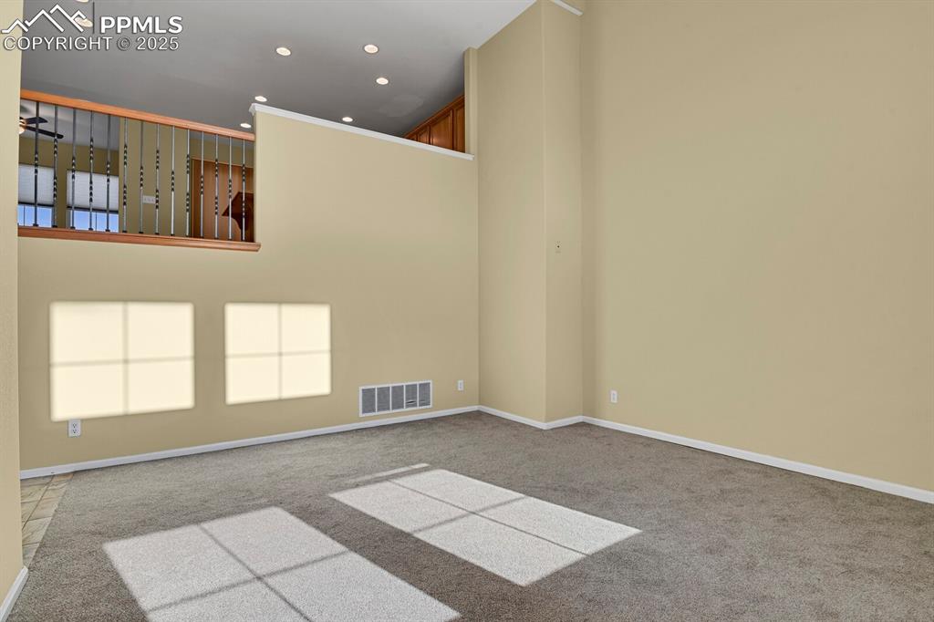 Image 16 of 45: Spare room with light carpet, recessed lighting, a high ceiling, and ceilin
