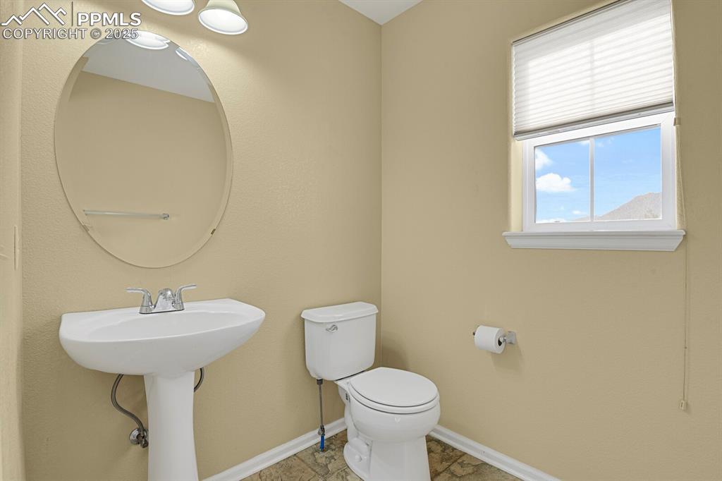 Image 18 of 45: Half bath featuring baseboards and toilet