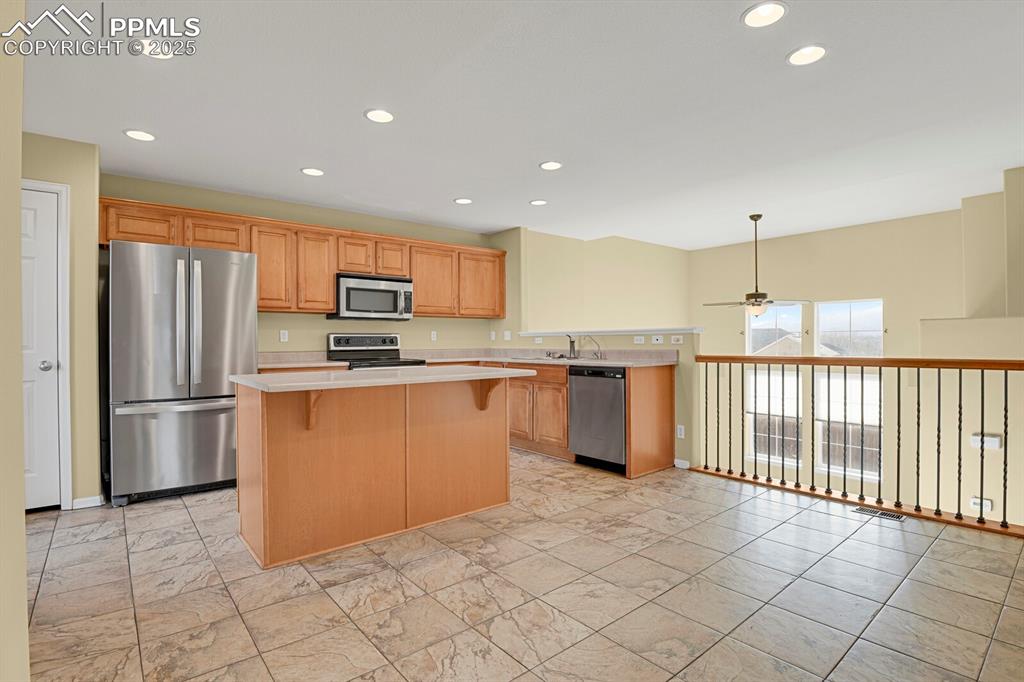 Image 20 of 45: Kitchen featuring appliances with stainless steel finishes, light counterto