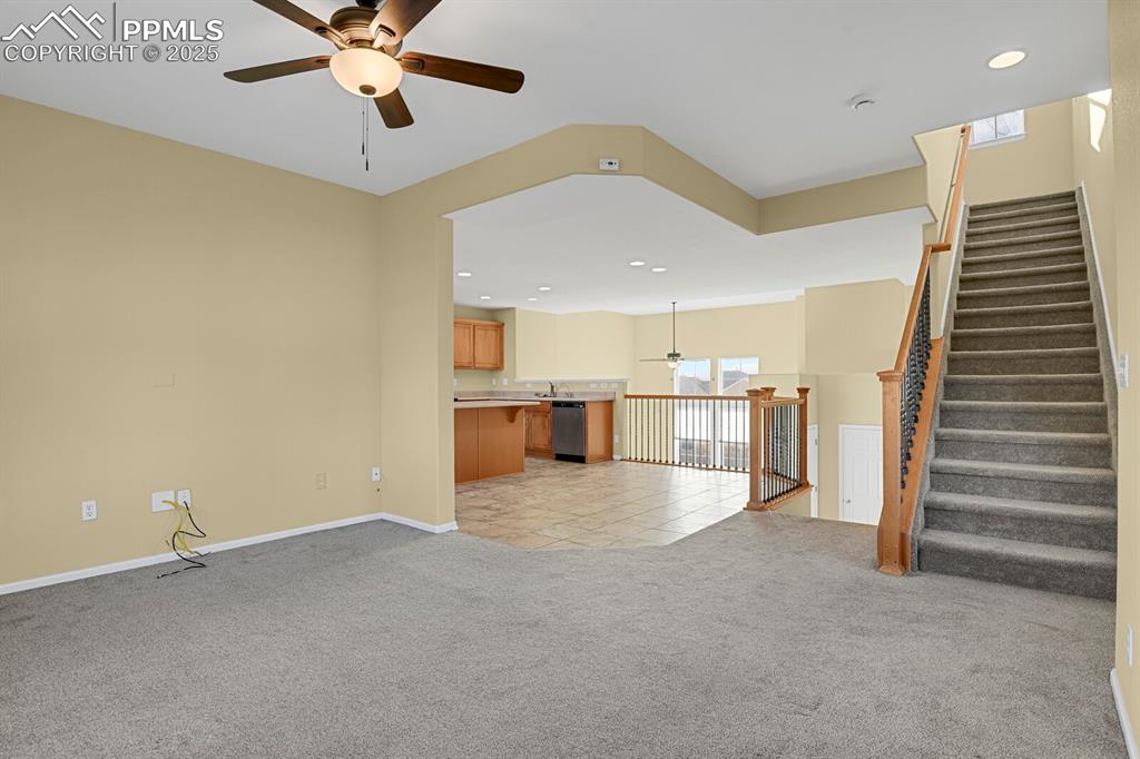 Image 26 of 45: Unfurnished living room featuring ceiling fan, light carpet, recessed light