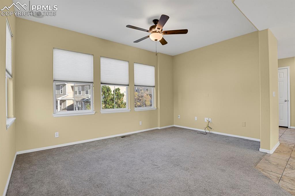 Image 27 of 45: Unfurnished room with light carpet and ceiling fan