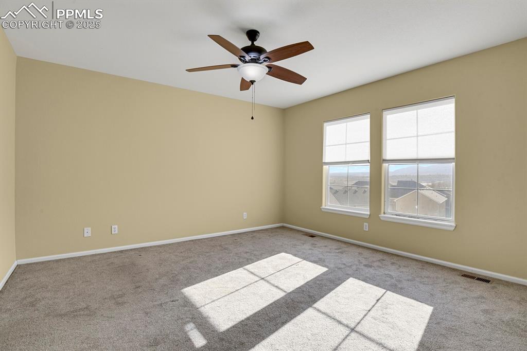 Image 29 of 45: Empty room featuring carpet and a ceiling fan